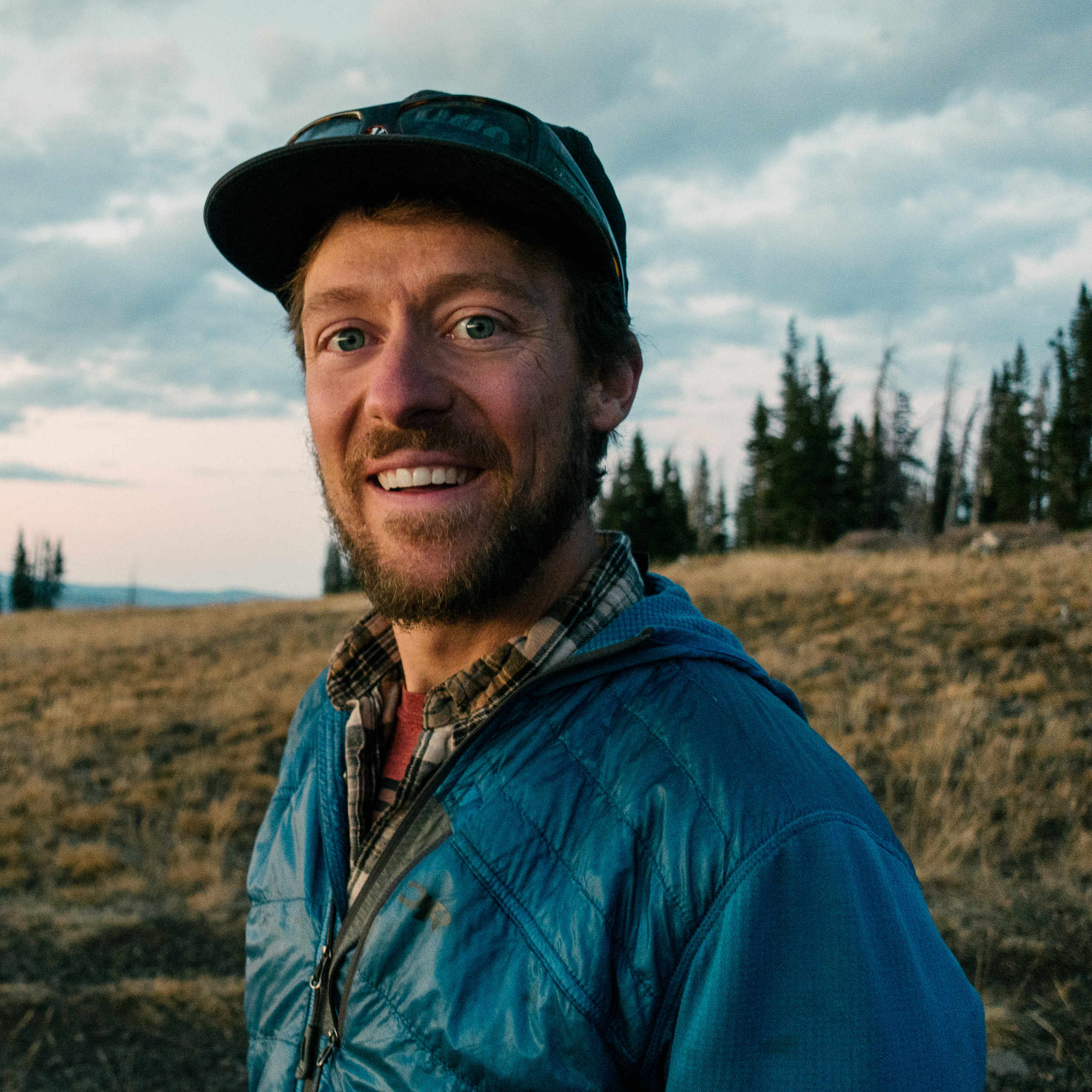 a man standing in front of a purple wall